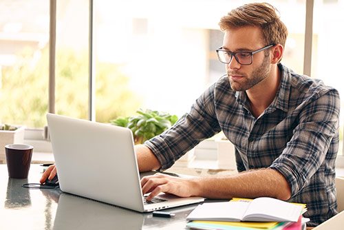 intesol-man-studying-on-laptop