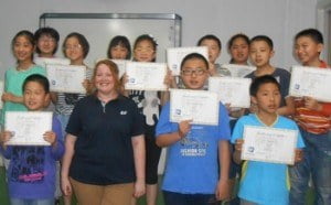 Kelly with students and diploma-350